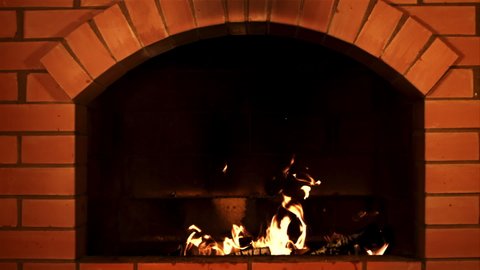 Wood burns in the fireplace. Against a dark background. Filmed is slow motion 1000 fps.