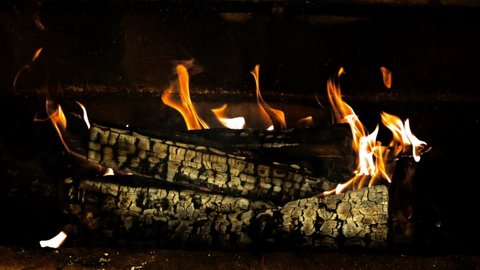 The fireplace burns with a bright flame of firewood. On a black background. Filmed on a high-speed camera at 1000 fps.