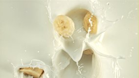 Pieces of banana fall into the milk with splashes. On a white background. Filmed is slow motion 1000 fps. - Powered by Shutterstock - Get 15% off with code: PIKWIZARD15