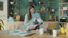 Mother Freelance Worker With Child From Home.Loving Woman Giving to Drink Milk to Her Son Using a Bottle. Mother Feeding Her Baby. Maternity Leave is Working From Home. Stress Mother Concept. - Powered by Shutterstock - Get 15% off with code: PIKWIZARD15