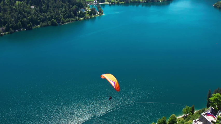 Paragliding Parachutes Flying Above Breathtaking Landscape of Lake Bled Slovenia - Drone Aerial View