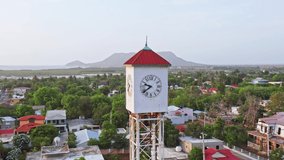 Clock tower at San Fernando de Montecristi with El Morro headland in background, Dominican Republic. Aerial sideways