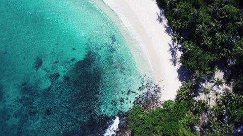 Professional video Aerial view of drone. Scene of top view beach and seawater in Andaman sea island. Nature and travel concept. Location Phuket Thailand 