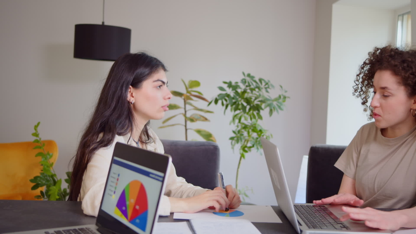 Confident female insurer consulting client about insurance benefits. Young businesswoman mentor, saleswoman, customer service manager teaching helping intern, giving business advice at office meeting. Royalty-Free Stock Footage #1090821749
