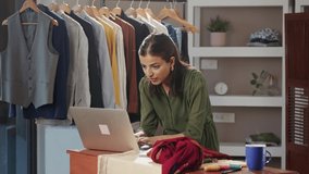 A modern Indian Asian woman or female working busy professional fashion designer is on a video call interacting or talking with a customer using a laptop. self-employment and woman empowerment concept