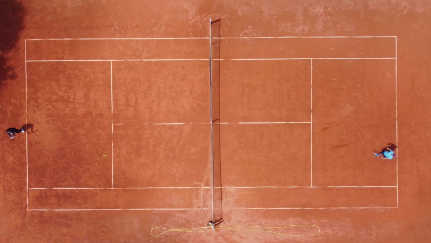 View from above, aerial view of two people playing tennis on a clay court Royalty-Free Stock Footage #1090824391