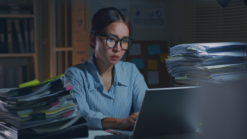 Young Asian office employee feeling tired, fatigue, exhausted while working overtime at night in office Royalty-Free Stock Footage #1090824769