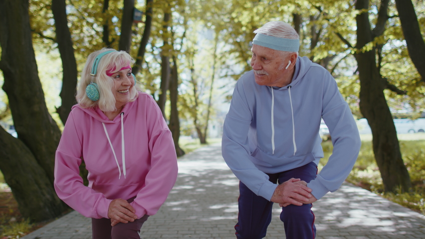 Athletic fitness senior elderly sport jogger man, woman training running cardio workout in summer park at morning. Old grandparents starting run race together. Active retired mature people motivation | Shutterstock HD Video #1090824955