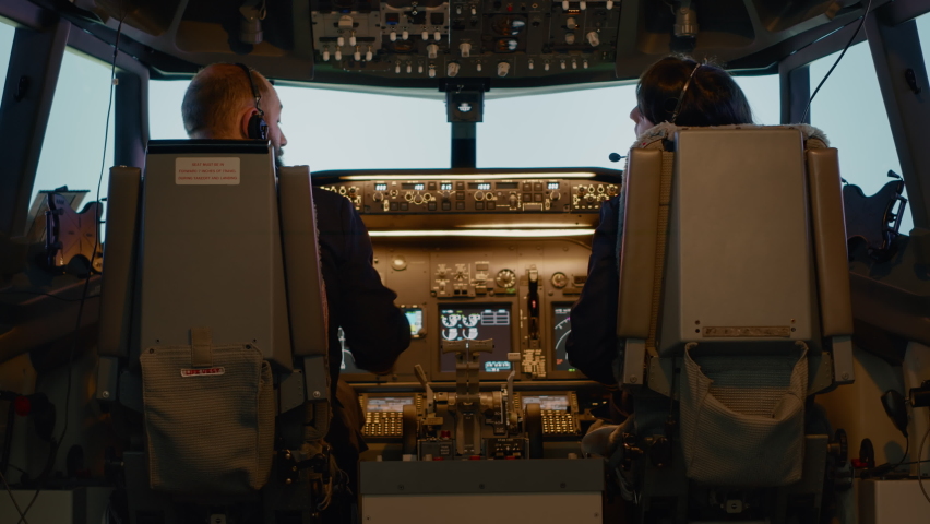 Plane captain and woman copilot fixing altitude on dashboard, using cockpit command with control panel to fly airplane. Aerial navigation to takeoff and use power engine, airline service. Royalty-Free Stock Footage #1090826725