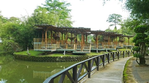 Kuala Lumpur, Malaysia - May 31,2022 : Landscape morning view of the Bamboo Playhouse in Kuala Lumpur Perdana Botanical Gardens, people can seen exploring around it.