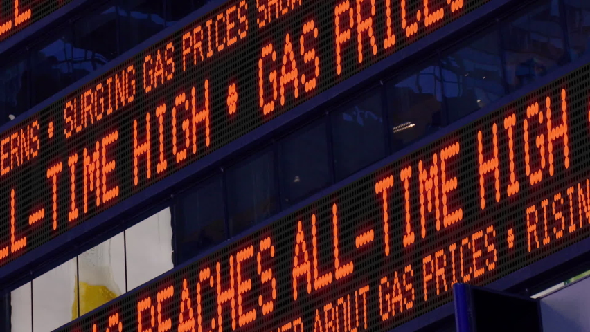 Closeup view of a Times Square ticker tells pedestrians about the rising cost of oil resulting in high gas prices.  	 Royalty-Free Stock Footage #1090834195