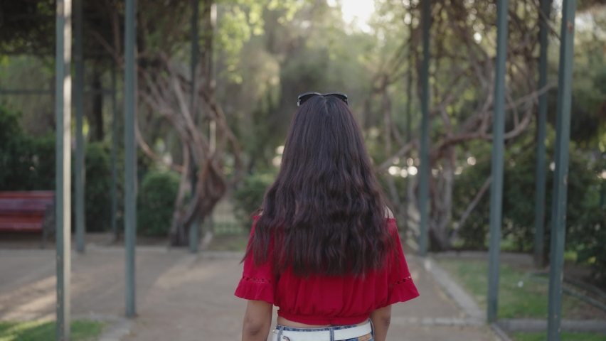 a pretty girl uses smiles when looking at the camera from the back to the front