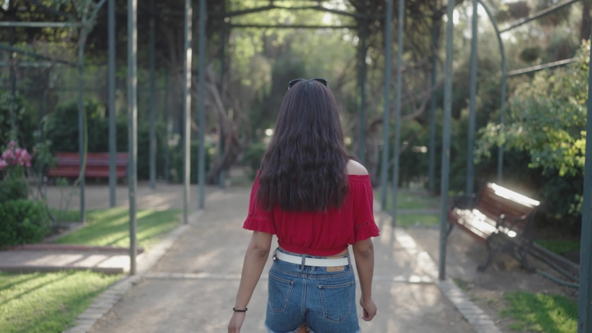 a pretty girl uses smiles when looking at the camera from the back to the front