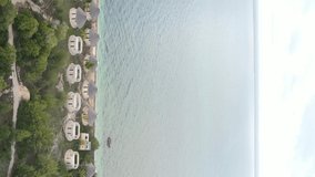 Vertical video of the ocean near the coast of Zanzibar, Tanzania, aerial view