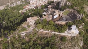 Aerial drone footage. The ancient Greek theatre and town of Taormina, Sicily, Italy.