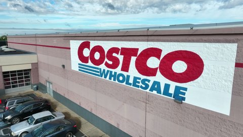 Lancaster , PA , United States - 05 30 2022: Aerial pull back shot of Costco sign on side of large building. Costco Wholesale; membership based grocery store. 