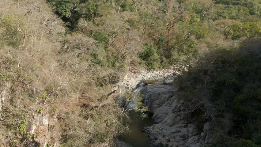 Yelapa Waterfall Flowing Down On Narrow River In Jalisco, Mexico. Aerial Pullback Shot