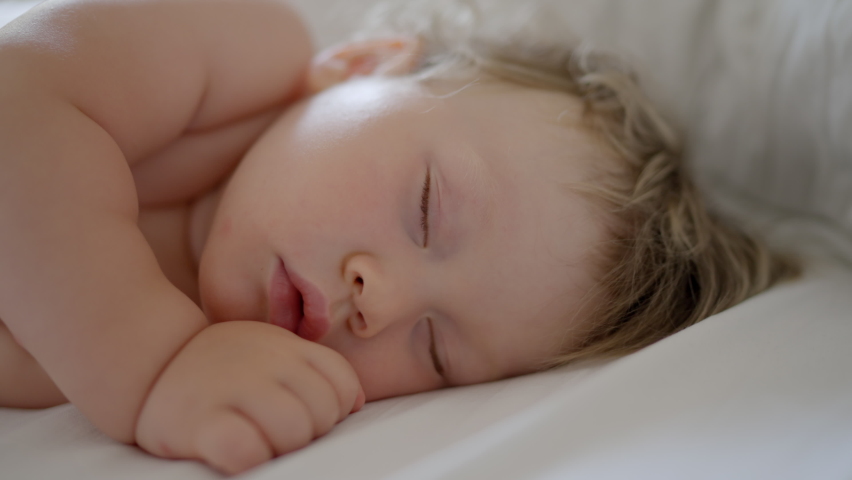 Peaceful baby boy sleeping bed in room. One year-old babyboy sleep home cute little toddler sleeps sweetly in crib sees colorful dream Sleeping baby happy and carefree in bed. Happiness sleep children | Shutterstock HD Video #1090853625
