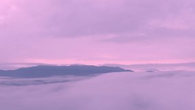 4k motion video, aerial view The beautiful morning view of the mist flowing on the high mountains due to the fresh air after the rain, Ban Pang Puai, Mae Moh, Lampang, Thailand.