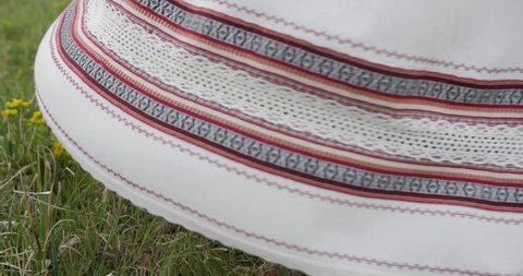 Ukrainian embroidered shirt, girl spinning on a background of grass