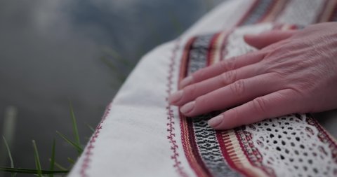 Ukrainian embroidered shirt, fingers touch the embroidered canvas