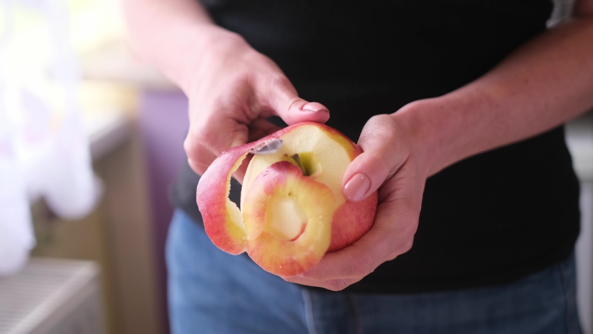 Apple pie preparation series - woman is peeling an apple by knife Royalty-Free Stock Footage #1090862661