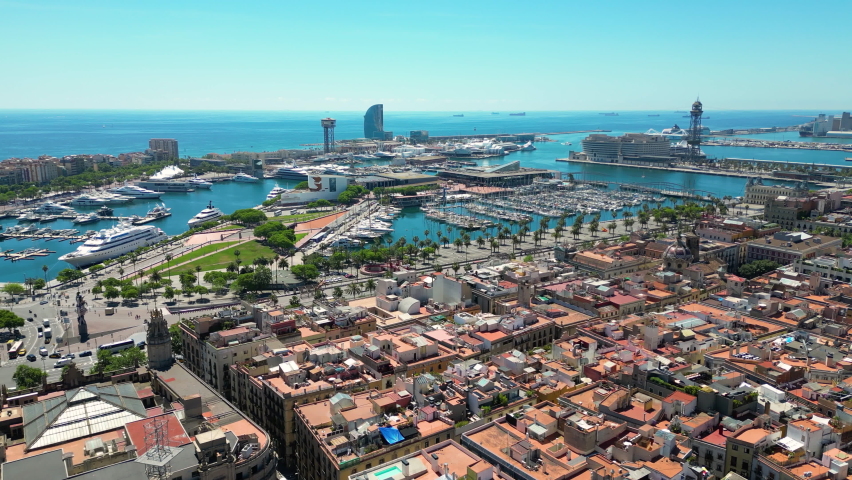 Aerial view over square Portal de la pau and Port Vell marina during a sunny day in Barcelona, Catalonia, Spain