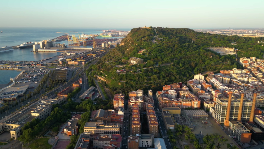 Aerial view of Montjuic hill with Montjuic Castle on it, sea cargo port of Barcelona. Panoramic seascape. Catalonia, Spain
