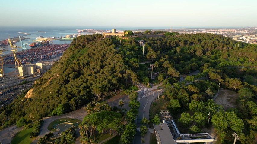 Aerial view of Montjuic hill with Montjuic Castle on it, sea cargo port of Barcelona. Panoramic seascape. Catalonia, Spain