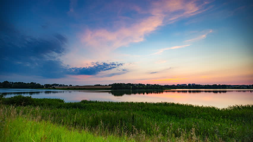 Landscape timelapse of beautiful after sunset sky over lake in Mazury lake district in Poland. 4k UHD Royalty-Free Stock Footage #10908689