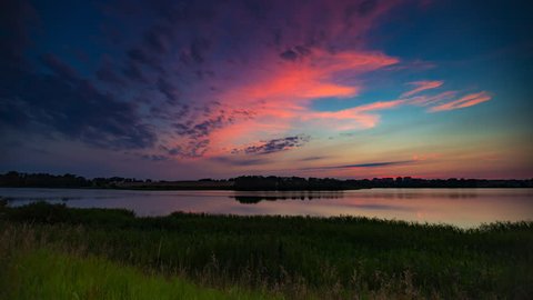 Landscape timelapse of beautiful after sunset sky over lake in Mazury lake district in Poland. 4k UHD