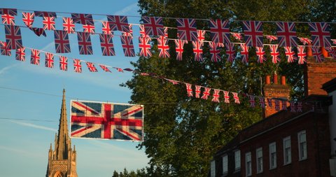 Union Jack flags flying from houses in the streets of Marlow in Buckinghamshire, England celebrating the Platinum Jubilee of Queen Elizabeth the Second in Summer 2022