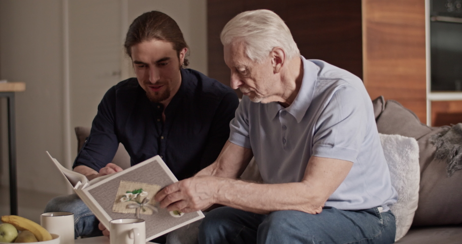 Father and son examining photos together