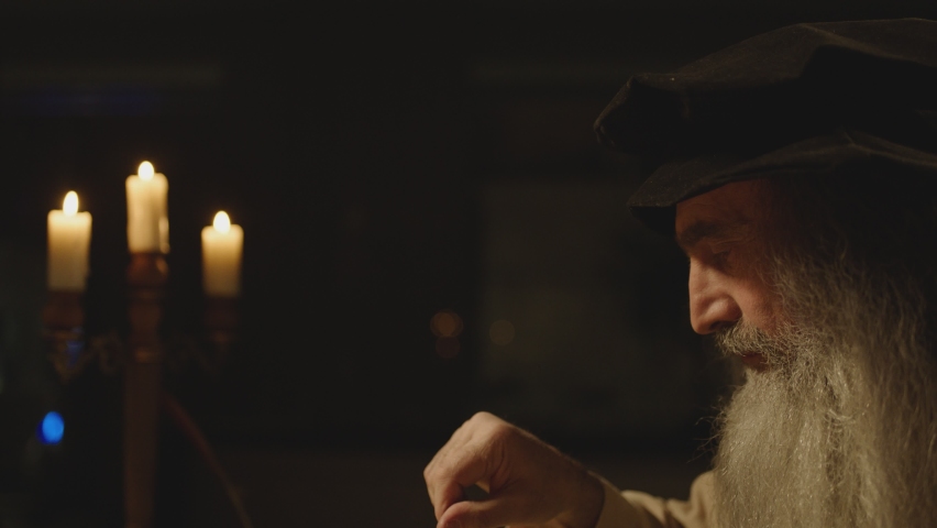 Old man or duplicate of LEONARDO DA VINCI writing , painting , working with divider in vintage designed room . Big drawing of famous artwork . Using , turning compass in Slow motion . 15 -16th century