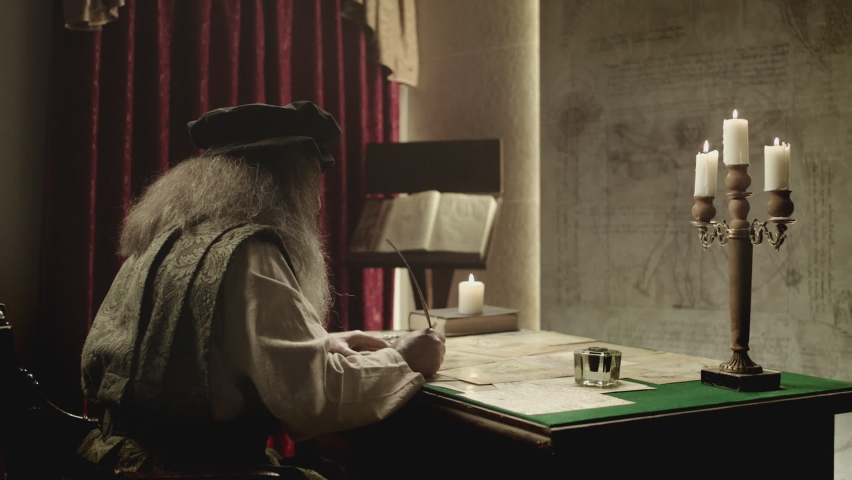 Old man with beard dressed like Leonardo Da Vinci writing , painting and working in vintage 15 - 16 century designed room . Big drawing of famous artwork  . Dipping ink pen on inkwell . Slow motion  Royalty-Free Stock Footage #1090877401