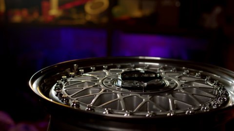 Moscow, Russia - CIRCA 2022: Close up view of three-piece forged wheels with classic pattern. Beautiful rims with chrome-plated shiny shelf with perfect polished bolts are spinning.