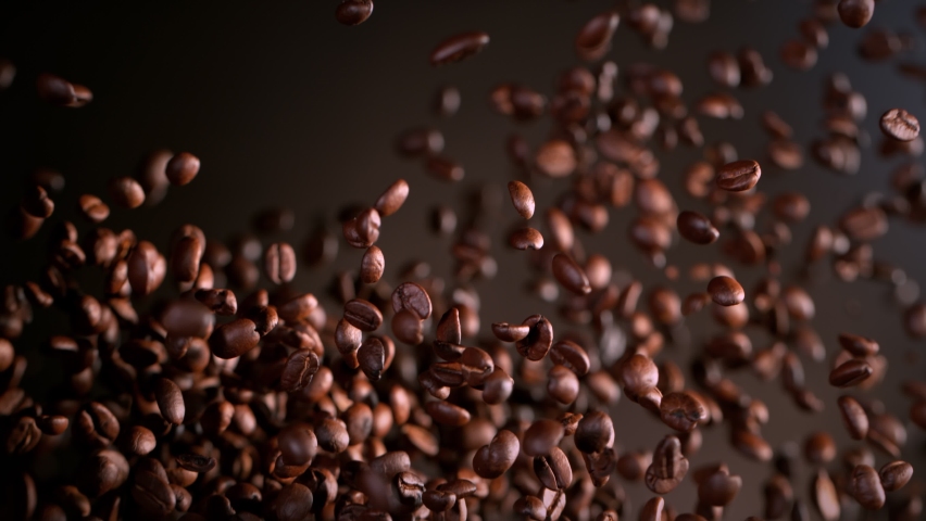 Super Slow Motion Shot of Exploding Premium Coffee Beans on Brown Gradient Background at 1000fps.