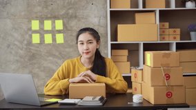 Happy young Asia businesswoman looking at camera selling introduce product to client video live streaming in online shop marketplace. Small business owner, online market delivery concept.
