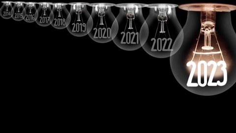 Shining light bulb with New Year 2023 and group of dark light bulbs in a row going from 2014 to 2022 isolated on black background. High quality 4k video. Adlı Stok Video