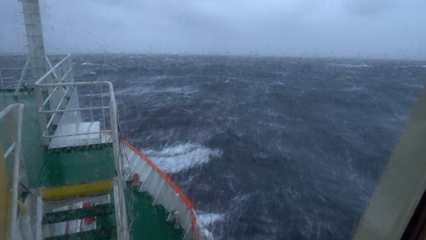Storm. Sea. Vessel. View from bridge. Bow breaks waves. A lot of splashes. Water completely splashed window. Strong pitching. High waves hit ship. White foam on water. Royalty-Free Stock Footage #1090884475