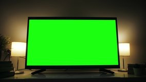 LcD smart TV screen with a blank green background in the living room. Chroma key screen for advertising.