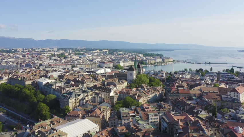 Inscription on video. Geneva, Switzerland. Flight over the city. Geneva Cathedral. Shimmers in colors purple, Aerial View, Point of interest