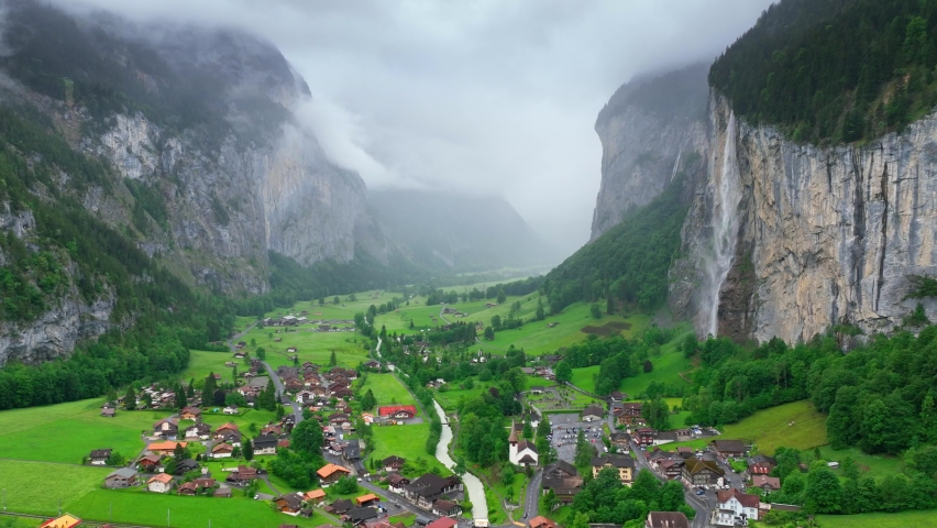 beautiful foggy Lauterbrunnen valley in Switzerland, scenic Swiss alpine village with waterfalls and fog, aerial view of famous natural landmark in Switzerland. High quality 4k footage Royalty-Free Stock Footage #1090886821