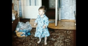 Small child standing in room, smiling. Happy baby in soviet apartment interior, stands on carpet, near toys, laughs, looks at parents. Family life. Vintage color film. Family archive. Retro 1980s. 4k 