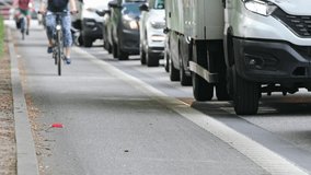 cyclists on the bike lane pass the traffic jam - Powered by Shutterstock - Get 15% off with code: PIKWIZARD15