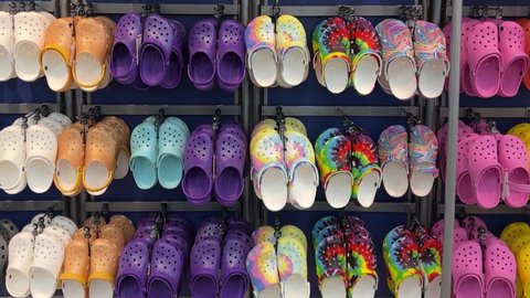 Springfield, IL USA - May 2, 2022: Panning up on rows of Crocs shoes at the Scheels Sporting Goods store in Springfield, Illinois.