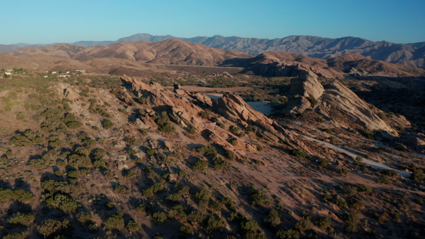 3d A lion stands among the prairies of a mountain valley. Monument Valley Sunrise.  Aerial views of the natural wonder. Drone point of view flying towards 