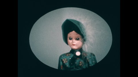 1960s: Images of dresser, clothes, dolls appear above children's heads. Children place fingers on button. Little girl looks unsure. Man talks.