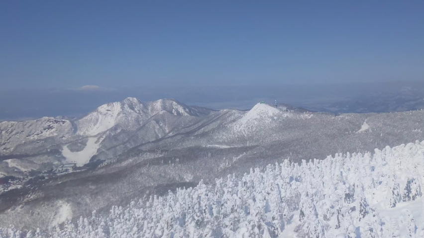 Looking over the snow monsters plateau and peaks from a gondola lift (Zao, Yamagata, Japan) Royalty-Free Stock Footage #1090896141