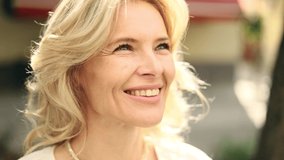 Portrait of attractive middle aged woman on the city street. Happy relaxed lady looking ahead on the city centre enjoying. - Powered by Shutterstock - Get 15% off with code: PIKWIZARD15
